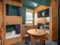 a room with a table and bunk beds at Eklo Paris Expo Porte de Versailles in Vanves