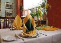 a table with yellow plates and napkins on a table at Hotel Am Schlossberg in Ziegenrück