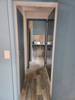 a hallway leading into a bathroom with wood flooring at Chambres d&#39;hôtes Le Montagné in Villeneuve-lès-Avignon