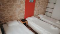 three beds in a room with a brick wall at Hôtel Hermance in Bellegarde-sur-Valserine