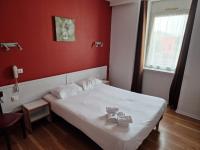 a bedroom with a bed with two teddy bears on it at Hôtel Hermance in Bellegarde-sur-Valserine