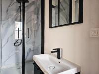 a bathroom with a white sink and a shower at L&#39;Idrac, Appartements en Hyper centre in Toulouse