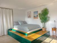 a bedroom with a bed on a wooden platform at L’Escale Borely in Marseille