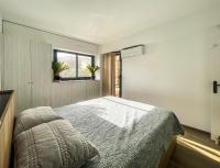 a bedroom with a bed and a window at L’Escale Borely in Marseille