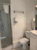 a bathroom with a shower and a toilet and a sink at Hotel Wilson Square in Toulouse