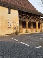 a building with a sign on the side of it at Maison Domme Dordogne in Domme