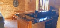 a kitchen with a black counter and a sink at Maison Domme Dordogne in Domme