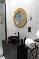 a bathroom with a black sink and a mirror at E Fauvette appartement de standing avec terrasse in Épernay