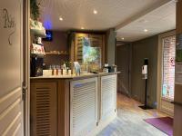 a kitchen with a counter with white drawers at Domaine du Clos Fleuri - Spa in Honfleur