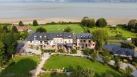 an aerial view of a large house on a hill near the water at Domaine du Clos Fleuri - Spa in Honfleur