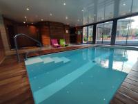 a large swimming pool in a building at Domaine du Clos Fleuri - Spa in Honfleur