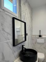 a bathroom with a black sink and a mirror at La maison de Giulia Menton in Menton