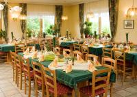 a dining room with green tables and chairs at Hotel Gasthof zur Linde in Mariahof