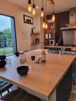 a kitchen with a wooden counter top with food on it at TY COAT - Maison neuve avec vue mer, piscine et bain nordique in Saint-Pabu