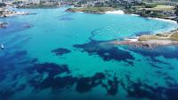 an aerial view of a beach with blue water at TY COAT - Maison neuve avec vue mer, piscine et bain nordique in Saint-Pabu