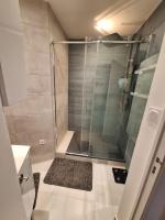 a shower with a glass door in a bathroom at Cosy Appartement in Paris 15th - Convention Center in Paris