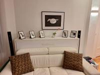 a living room with a white couch and pictures on a wall at Cosy Appartement in Paris 15th - Convention Center in Paris