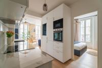 a large white kitchen with a glass counter top at Charmant appartement haut de gamme in Bordeaux