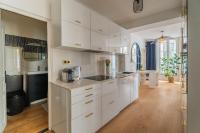 a kitchen with white cabinets and a counter top at Charmant appartement haut de gamme in Bordeaux