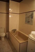 a bathroom with a tub and a toilet at Aux Trois Jean in Le Crotoy