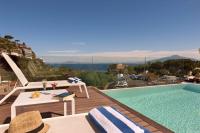 a pool with a table and chairs next to a building at Hotel Rivage in Sorrento