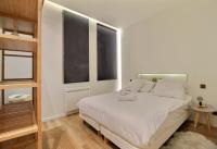 Łóżko lub łóżka w pokoju w obiekcie APPARTEMENT PARIS - LOUVRE & RIVOLI
