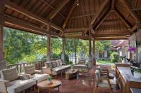 an outdoor living room with a large wooden pavilion at Santi Mandala Villa & Spa in Sukawati