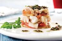 een wit bord met een stapel eten op een tafel bij Andes Suites in Santiago