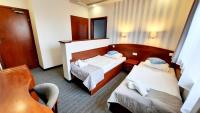 a hotel room with two beds and a mirror at Malachit Karpacz SPA Hotel in Karpacz