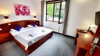 a bedroom with a bed with two teddy bears on it at Malachit Karpacz SPA Hotel in Karpacz