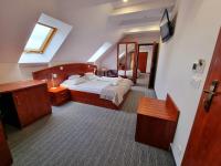 a bedroom with a large bed and a mirror at Malachit Karpacz SPA Hotel in Karpacz
