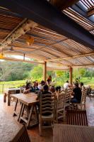 a group of people sitting at a table in a restaurant at El EQUIMITE HOTEL BOUTIQUE in Coatepec
