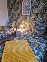 a living room with a couch and a table at Chez Aurélie et Bruno in Montceau-les-Mines