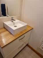 a bathroom with a white sink and a mirror at Chez Aurélie et Bruno in Montceau-les-Mines