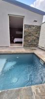 a swimming pool in front of a house at LOCATION LA MONTAGNE MARTINIQUE in Le Vauclin