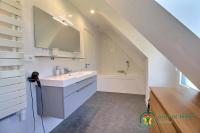 a white bathroom with a sink and a tub at Villa mimosas in Brech