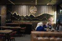 two women sitting at a table in a restaurant at My Home Hotel Pontianak in Pontianak