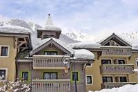 a large building with snow on top of it at Résidence La Ginabelle - maeva Home - Appartement 4 Pièces 8 Personnes - S 444 in Chamonix