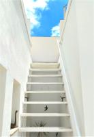 a staircase leading up to a house with white walls at Vejerísimo Casa Boutique in Vejer de la Frontera