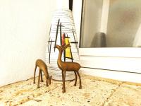 a small figurine of two deer standing next to a window at Vejerísimo Casa Boutique in Vejer de la Frontera