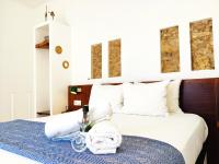a bedroom with a bed with a blue and white blanket at Vejerísimo Casa Boutique in Vejer de la Frontera