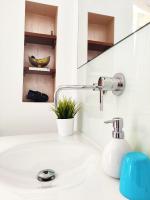 a bathroom sink with a faucet and a mirror at Vejerísimo Casa Boutique in Vejer de la Frontera