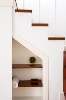 a clock sitting on a shelf under a staircase at Vejerísimo Casa Boutique in Vejer de la Frontera