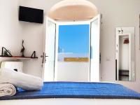 a bedroom with a blue bed with a sliding glass door at Vejerísimo Casa Boutique in Vejer de la Frontera