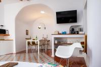 a living room with white chairs and a table at Vejerísimo Casa Boutique in Vejer de la Frontera