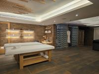 a bedroom with a bed in a room with brick walls at Maximus Hotel Byblos in Jbeil