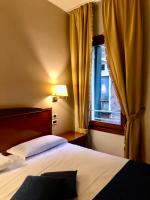 a hotel room with a bed and a window at Locanda del Ghetto in Venice