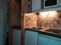a kitchen with a sink and a microwave at Résidence Chaviere - Studio pour 2 Personnes 034 in Les Menuires