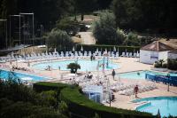 a large swimming pool with people sitting around it at Résidence Port Bourgenay - maeva Home - Appartement 3 Pièces 7 Personnes - 714 in Talmont