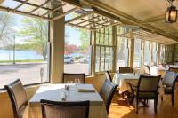 a restaurant with tables and chairs and a large window at Hannum House in Skaneateles